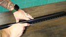 Image One Impact Sooper Edge Black Ruler shown in use.